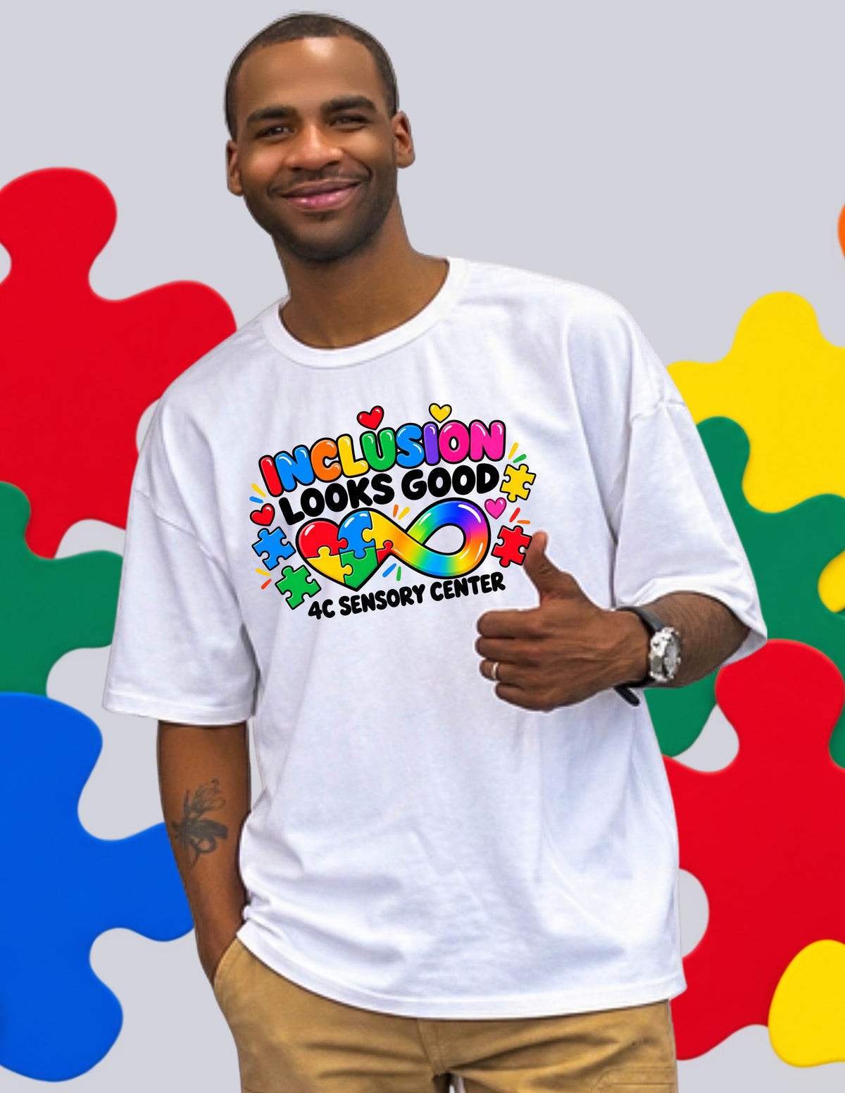 Man wearing the white Inclusion Looks Good tee by 4C Sensory Center